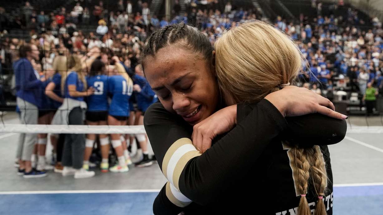 Lone Peak’s Jayda Tupea, left, and Kalia Kohler embrace each other as they celebrate their win against Pleasant Grove in the 6A volleyball state championship at the UCCU Center in Orem on Saturday, Nov. 6, 2021.
