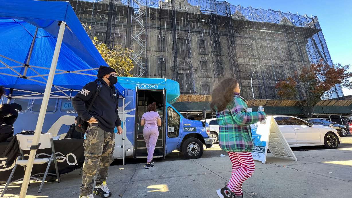 A girl walks outside of a mobile vaccine unit after getting the first dose of her COVID-19 vaccine, outside P.S. 277, Friday, in the Bronx borough of New York.