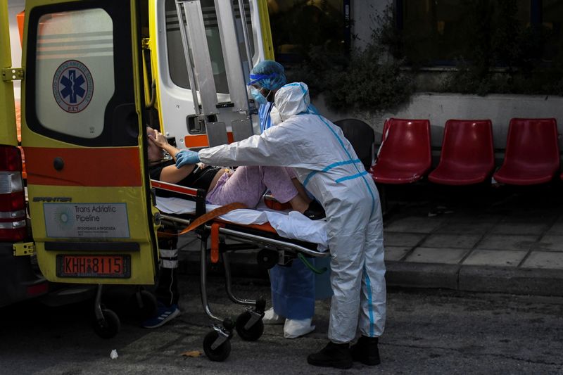 Medical workers carry a patient as she arrives at the coronavirus disease ward of the Ippokrateio General Hospital in Thessaloniki, Greece, on Nov. 3.