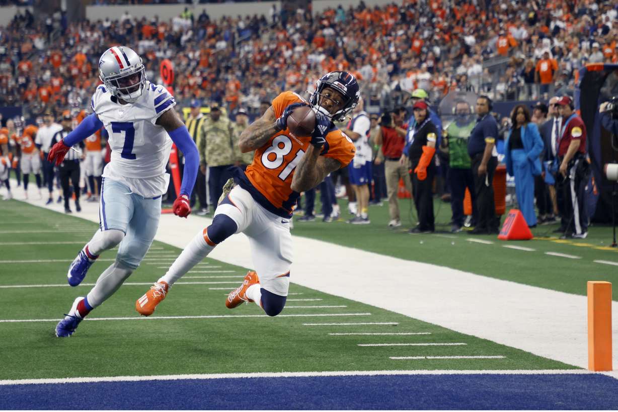 Dallas Cowboys cornerback Trevon Diggs (7) defends as Denver Broncos wide receiver Tim Patrick (81) catches a touchdown pass in the first half of an NFL football game in Arlington, Texas, Sunday, Nov. 7, 2021.