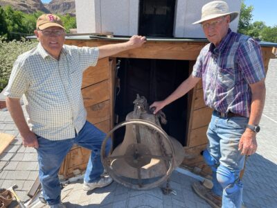David Isom, left, and Larry LeBaron, members of the Hurricane Valley Chapter of the Sons of Utah Pioneers, pose next to the old Hurricane bell the day it was removed from the steeple of the Old Red Brick Church in Hurricane on May 21.