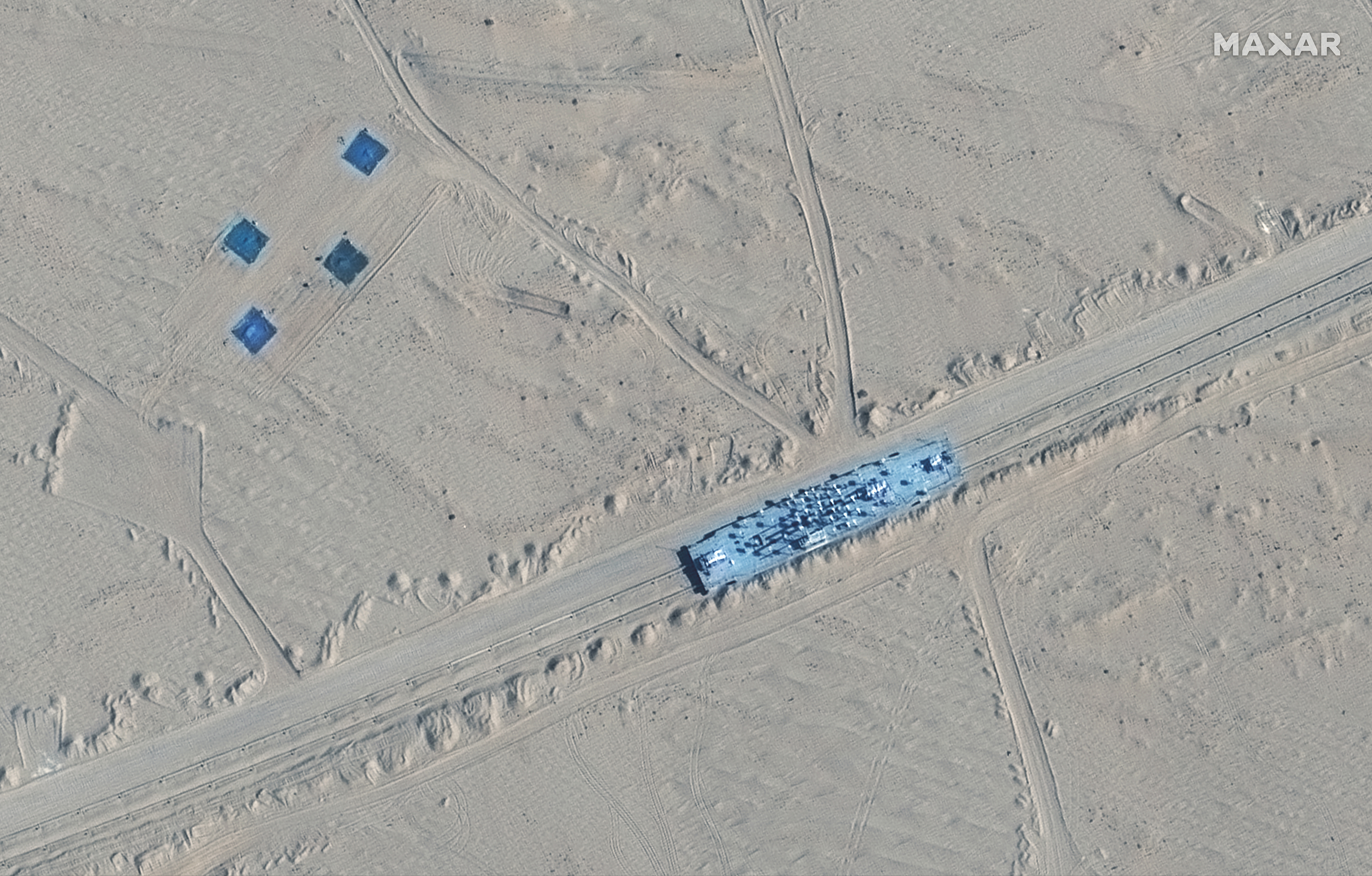 This image shows a building on rail tracks in Ruoqiang County, China, on Oct. 20. Satellite images appear to show China has built mock-ups of U.S. Navy aircraft carriers and destroyers in its northwestern desert. 