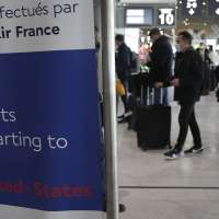 Travelers line up for US flights as curbs are lifted for first time