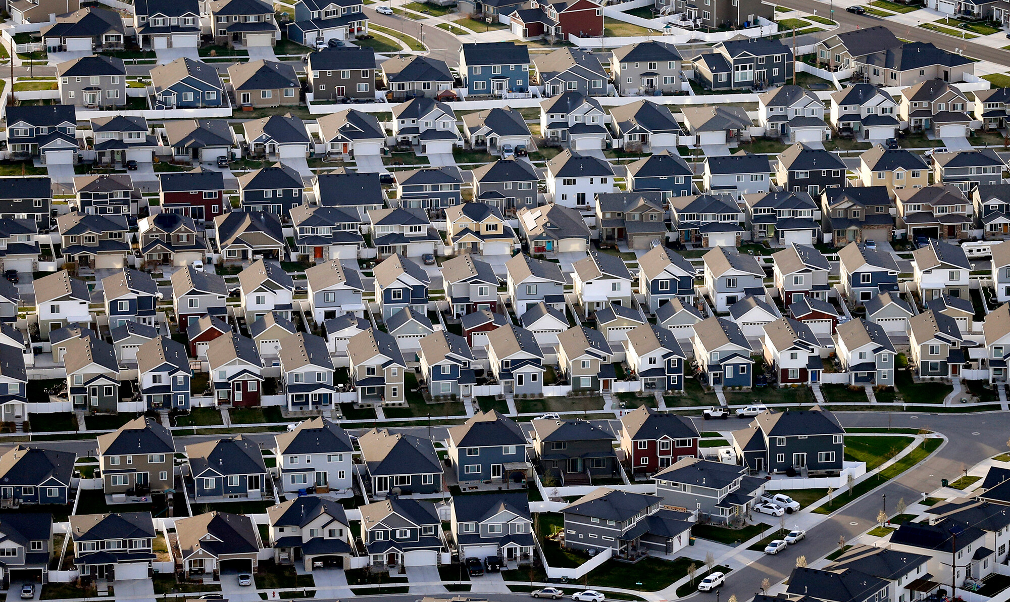 This photo shows rows of homes in suburban Salt Lake City on April 13, 2019. Over the past couple of years, real estate giants like Zillow and Redfin moved beyond online listings of available homes for sale, and started buying and reselling homes.