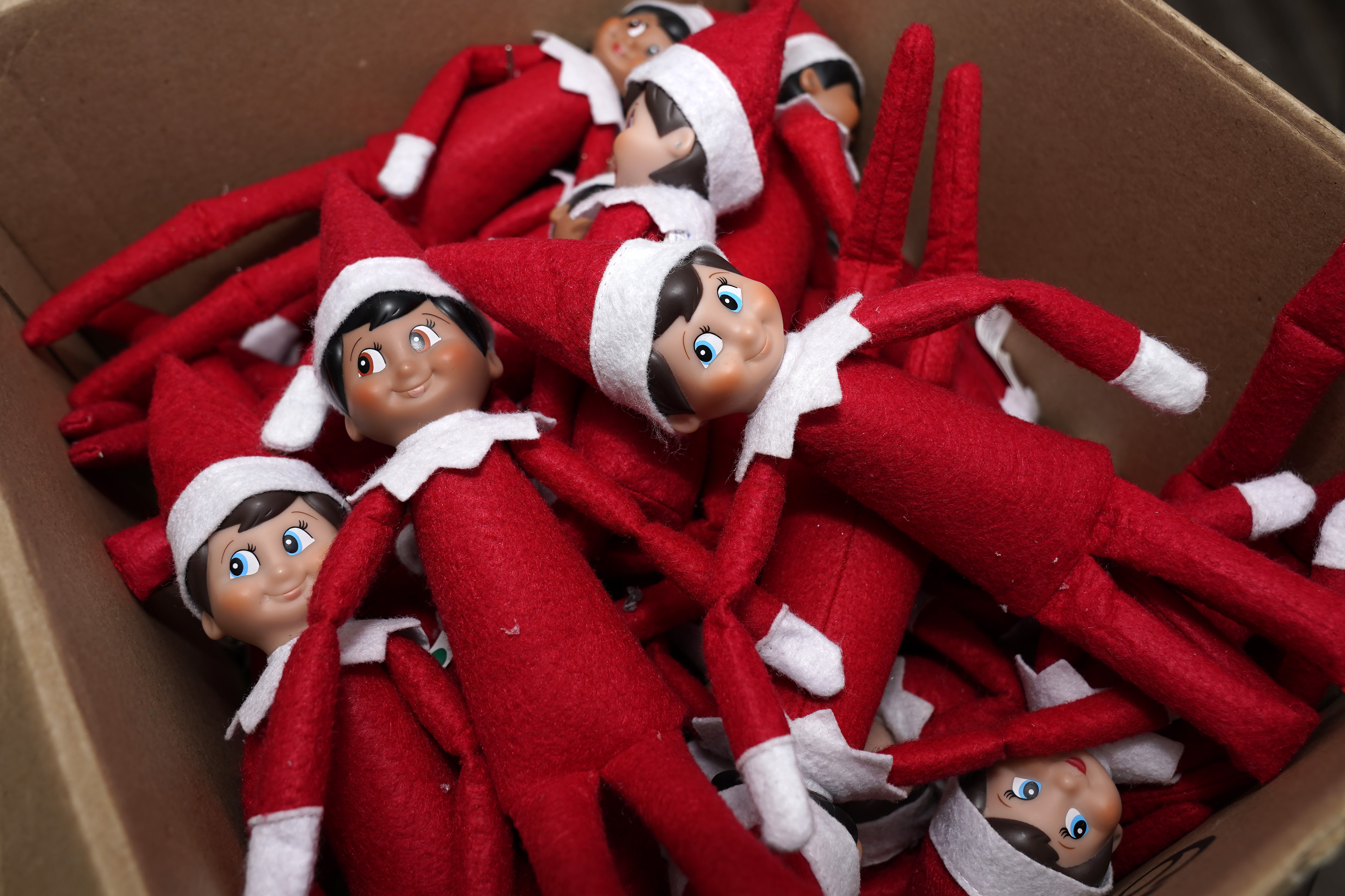 Elf on the Shelf figures are piled in a box Aug. 27, 2020, in Atlanta. A judge — jokingly — banned the Elf on the Shelf as a “gift to tired parents.”