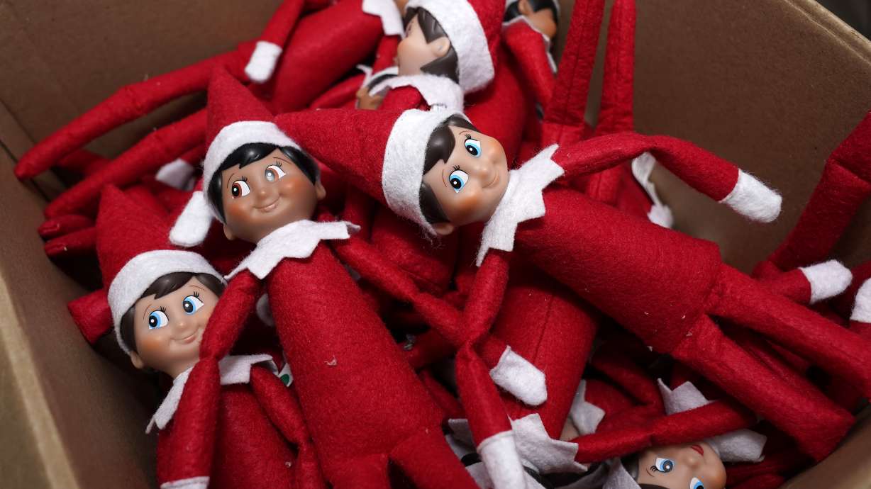Elf on the Shelf figures are piled in a box at the company's studio Aug. 27, 2020, in Atlanta.