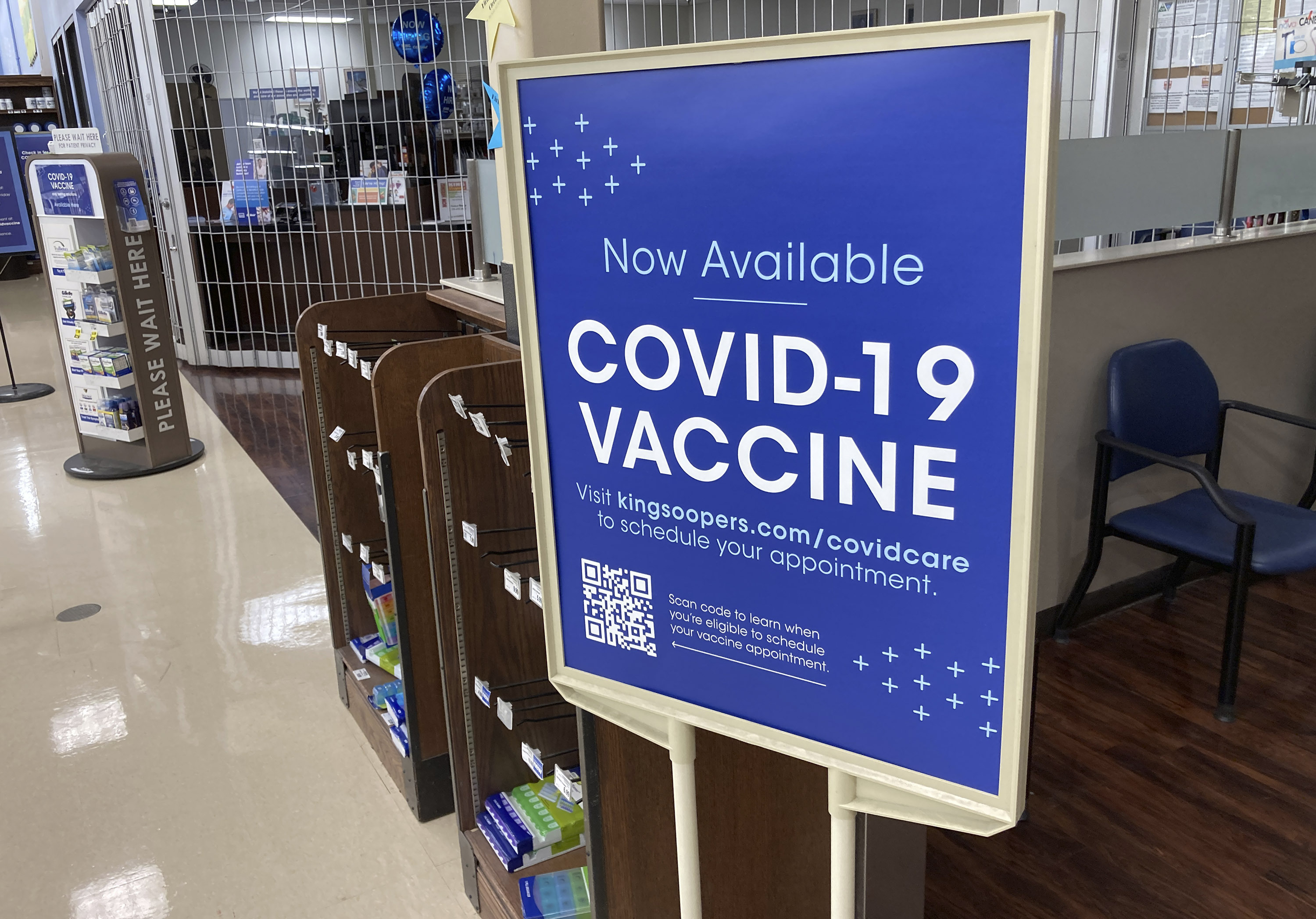 A sign notifies grocery customers that COVID-19 vaccinations are available at a pharmacy in a grocery store in Monument, Colo, on, Oct. 23.
