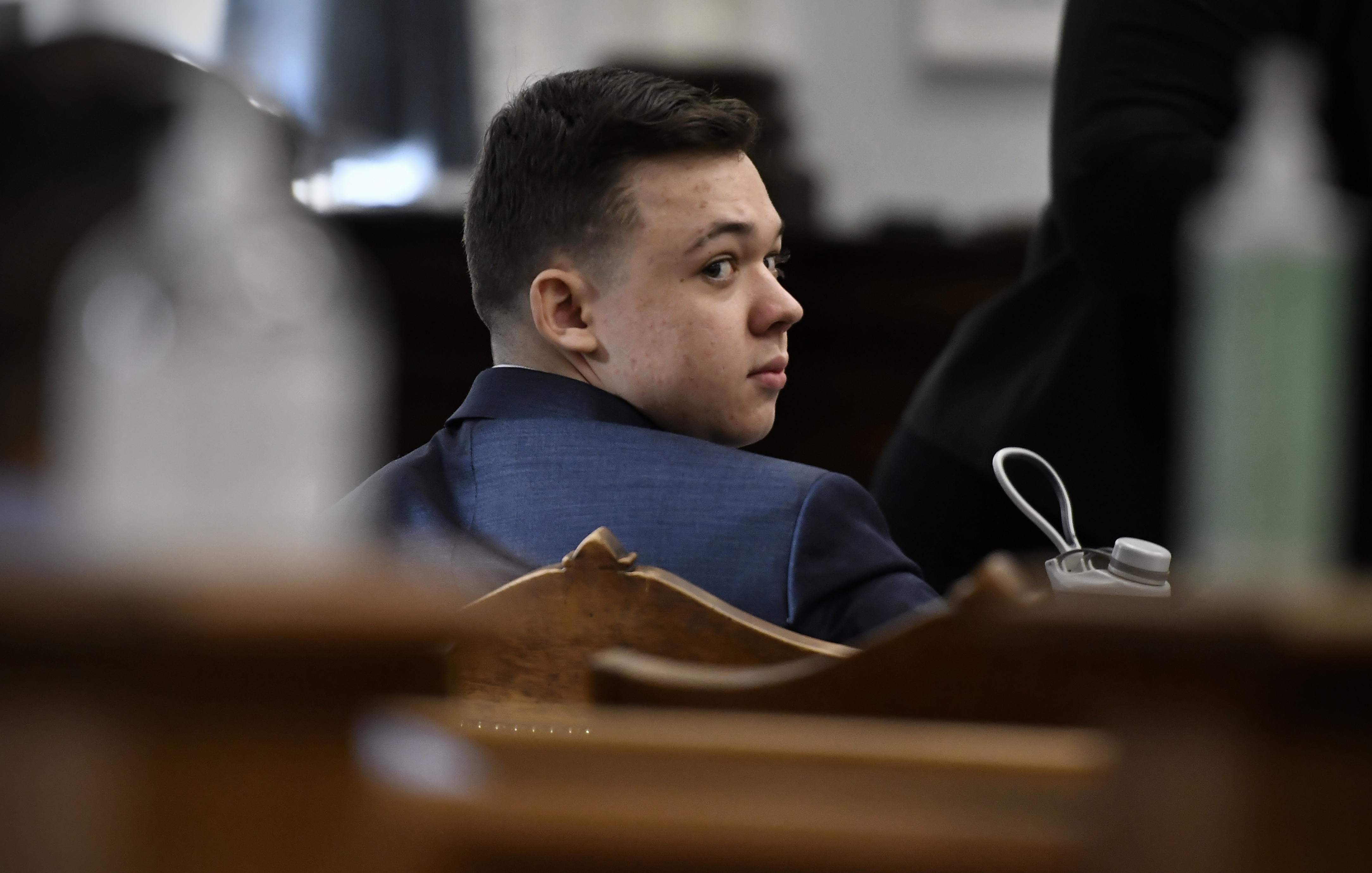 Kyle Rittenhouse looks back before his trial starts at the Kenosha County Courthouse in Kenosha, Wis., on Monday.

