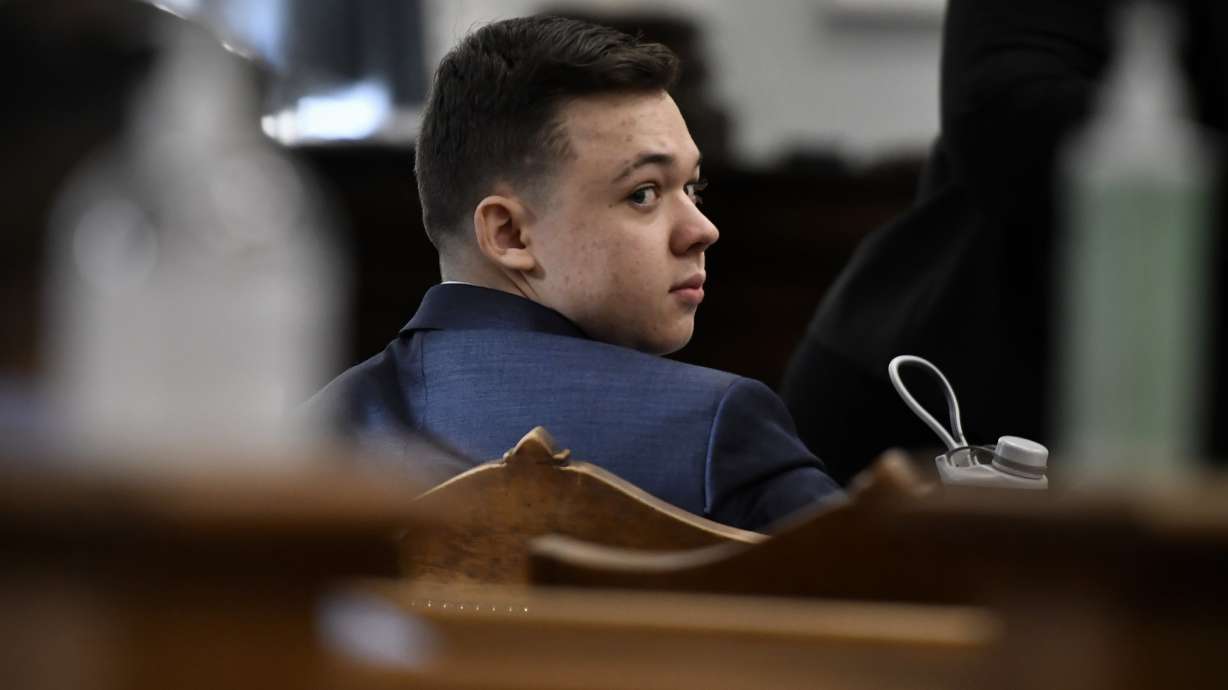 Kyle Rittenhouse looks back before his trial starts at the Kenosha County Courthouse in Kenosha, Wis., on Monday.