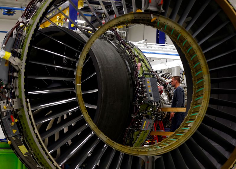 A General Electric employee inspects a jet engine at the GE Aviation Peebles Test Operations Facility in Peebles, Ohio, Nov. 15, 2013.