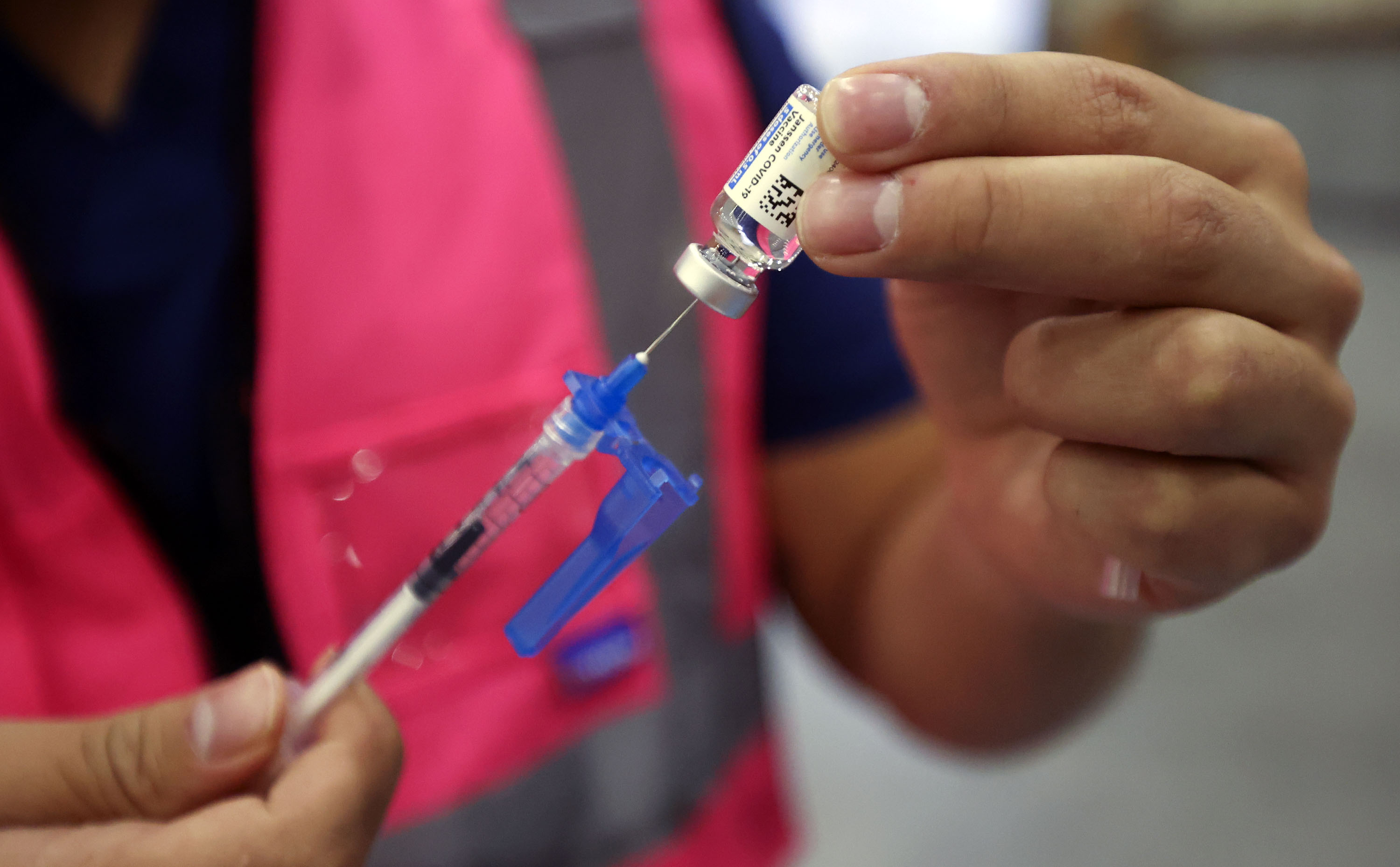 Davis County community health nurse Bruno Gonzalez gets a vial of the Johnson & Johnson COVID-19 vaccine to prepare booster doses at the Legacy Events Center in Farmington on Monday, Oct. 25. Utah health officials reported 1,558 new COVID-19 cases and 13 new deaths on Tuesday.