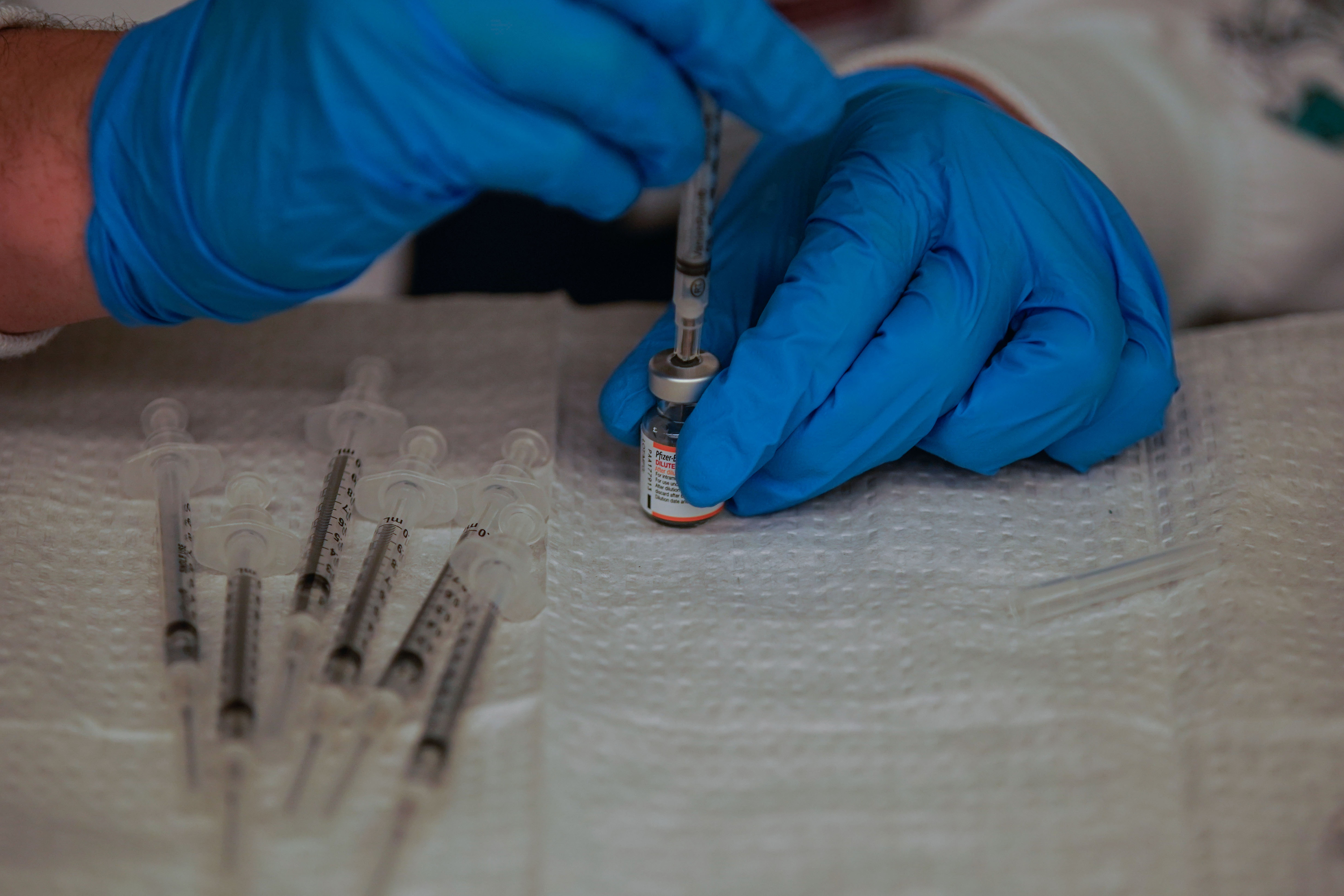 Zachary Krush, with the Salt Lake County Health Department, prepares a Pfizer-BioNTech COVID-19 vaccination at South Main Public Health Center in Salt Lake City on Nov. 3.