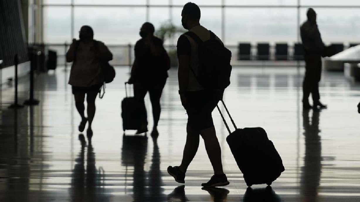 Travelers move through Salt Lake City International Airport on Aug. 17. The U.S. says that it's inviting the global community to visit now that the government has ended the ban on travelers from 33 countries. In reality, however, it will still be difficult for much of the globe to enter the country.