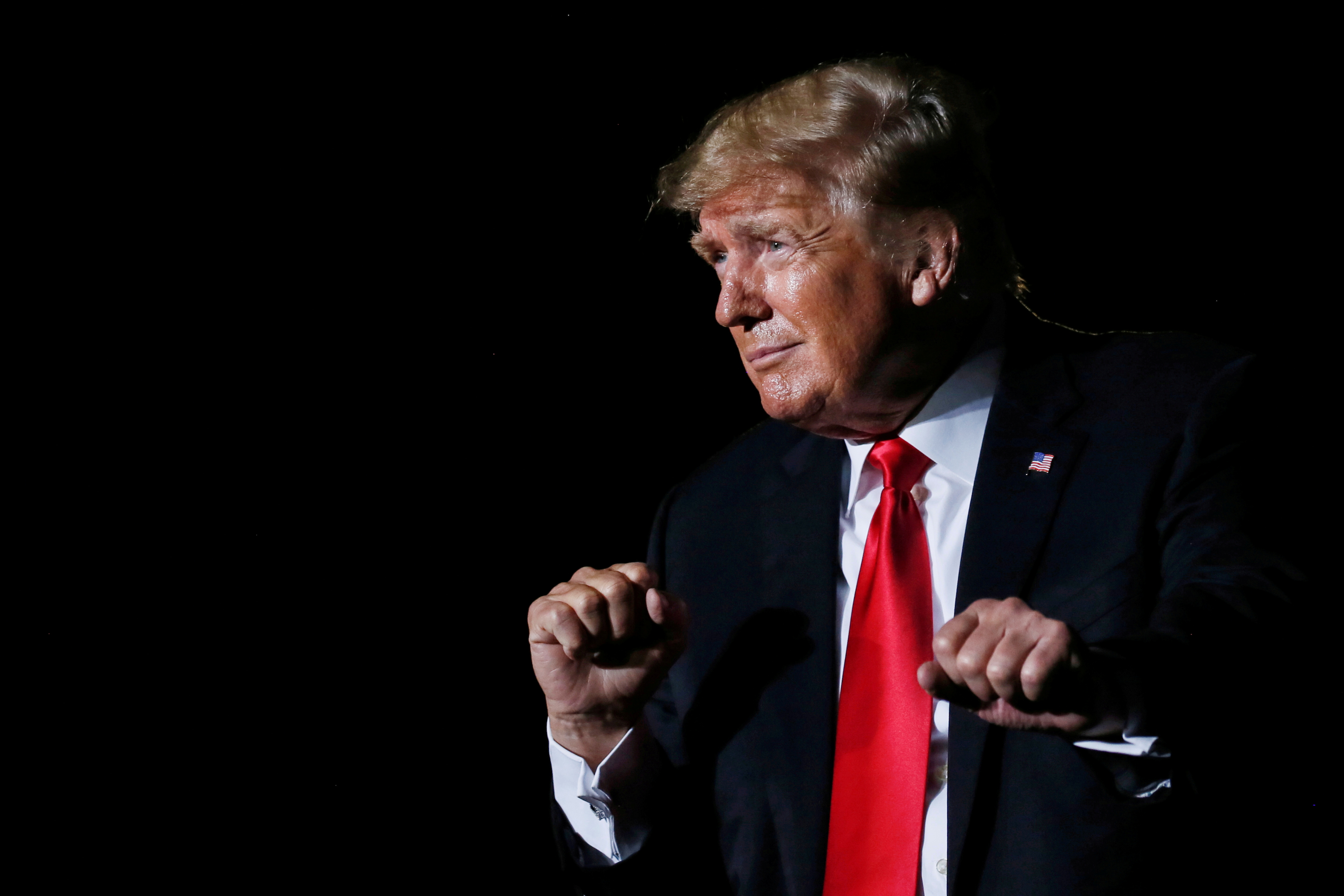 Former U.S. President Donald Trump reacts after his speech during a rally at the Iowa States Fairgrounds in Des Moines, Iowa, on Oct. 9. A U.S. government agency on Tuesday said 13 senior members of the former president's administration violated a law that limits political campaigning by government employees.