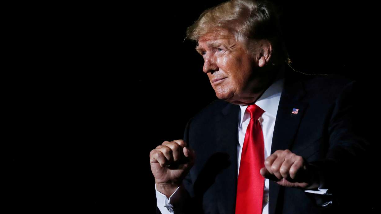 Former U.S. President Donald Trump reacts after his speech during a rally at the Iowa States Fairgrounds in Des Moines, Iowa, on Oct. 9. A U.S. government agency on Tuesday said 13 senior members of the former president's administration violated a law that limits political campaigning by government employees.