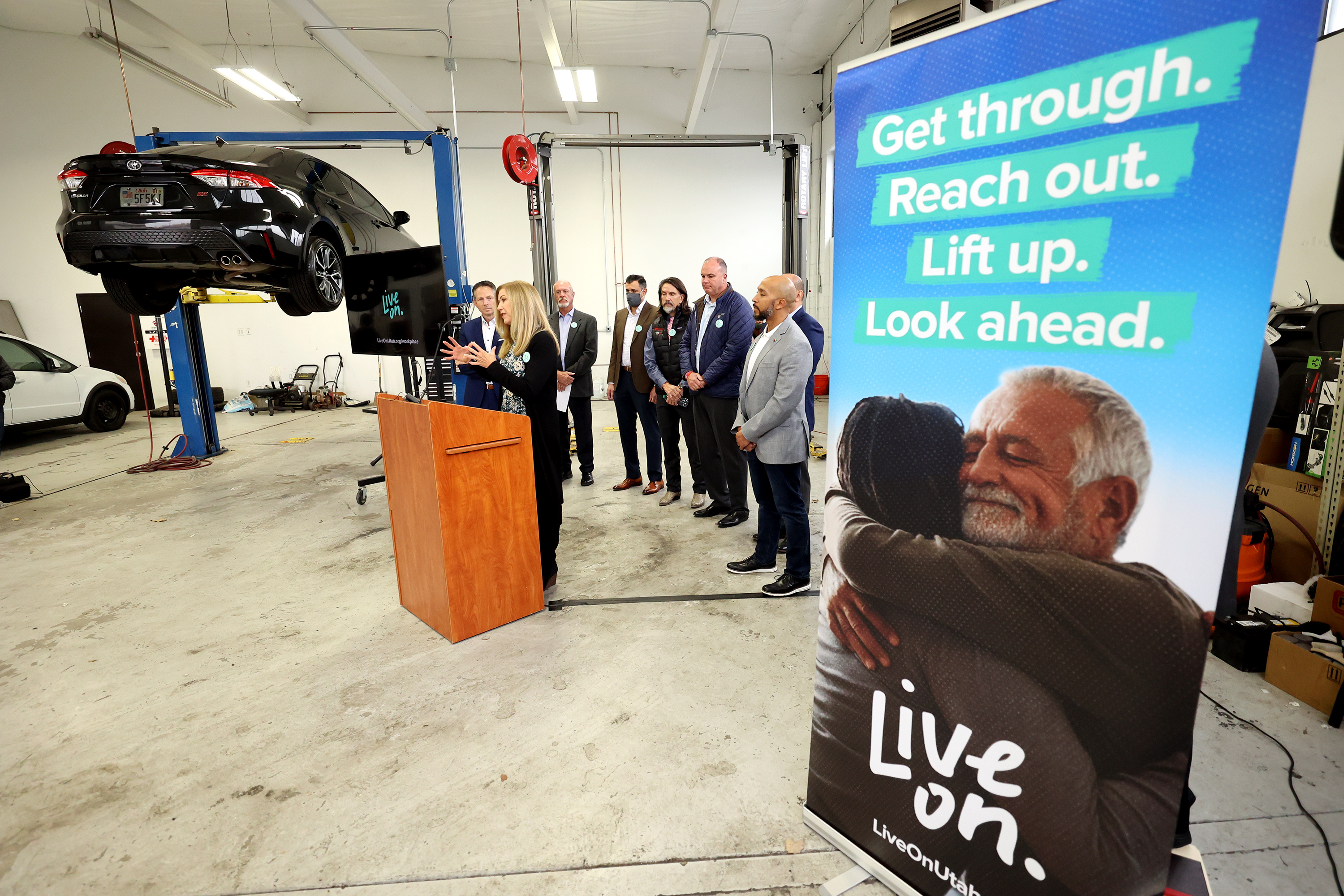 Judy Copier, market president for iHeart Media, speaks as the Salt Lake Chamber and business leaders hosts a press event unveiling a new suicide prevention and mental health campaign dedicated to helping employers and employees from the private sector, at Strong Volkswagen used cars in Salt Lake City on Tuesday. 