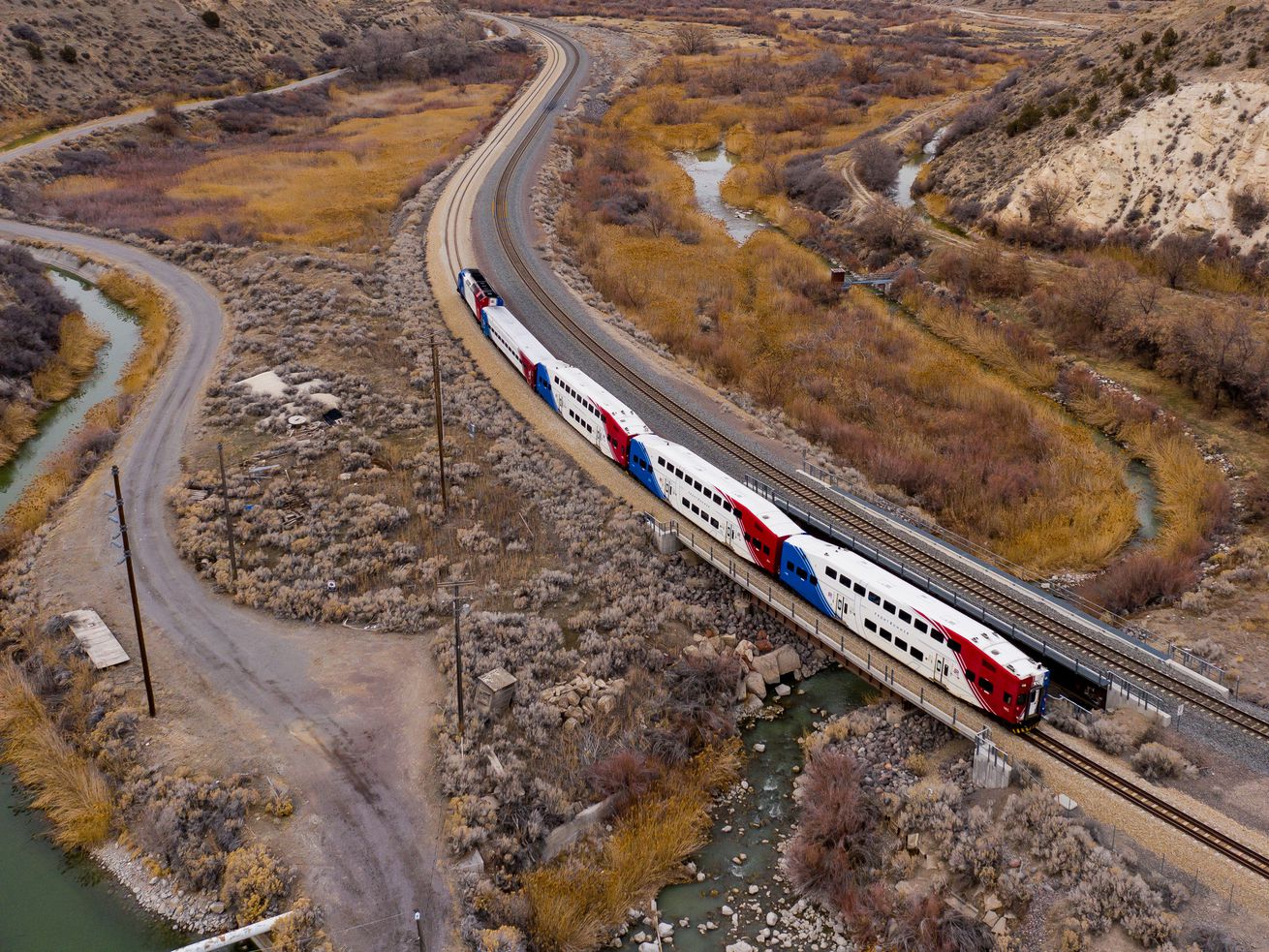 A FrontRunner train travels through the Jordan Narrows,
with its single rail line running next to a Union Pacific line, on
the border of Riverton and Bluffdale on Thursday, Feb. 25.