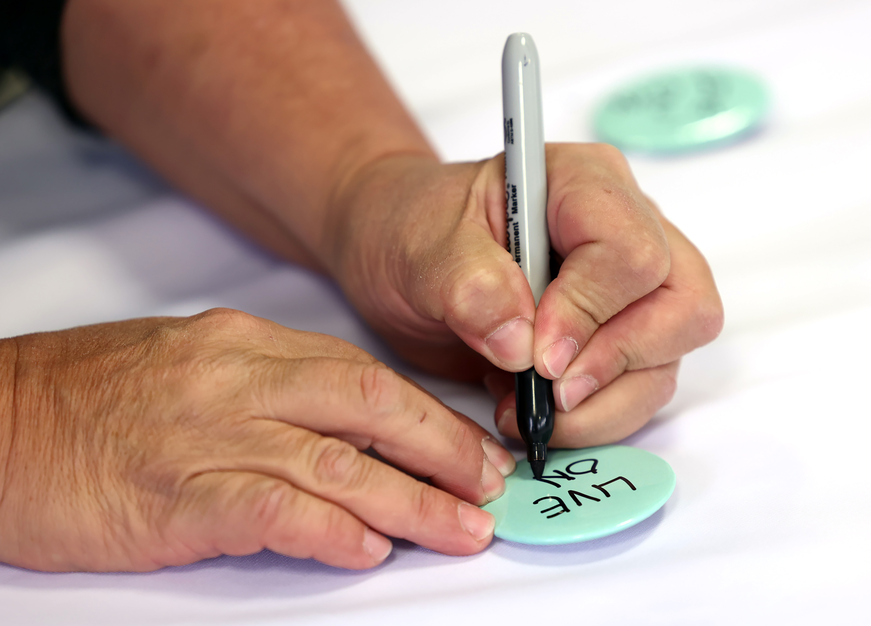 Buttons for Live On Utah, a suicide prevention and mental health campaign, on Nov. 9, 2021. The Utah Department of Health and Human Services said Wednesday the suicide rate went up in 2022, but the use of prevention resources went up, too.