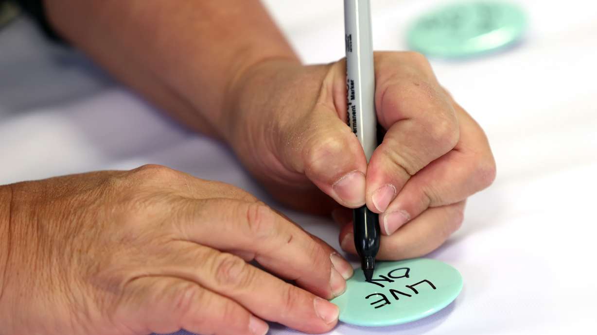 Buttons with “LIVE ON” were worn by those in attendance at a Salt Lake City suicide prevention and mental health event on Nov. 9, 2021. A new report released by the Utah Women and Leadership project on Wednesday revealed how Utah's women and girls may be at risk for suicide.