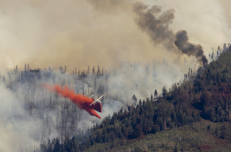 An air tanker drops retardant on the Parley’s Canyon
fire west of Park City on Aug. 14.