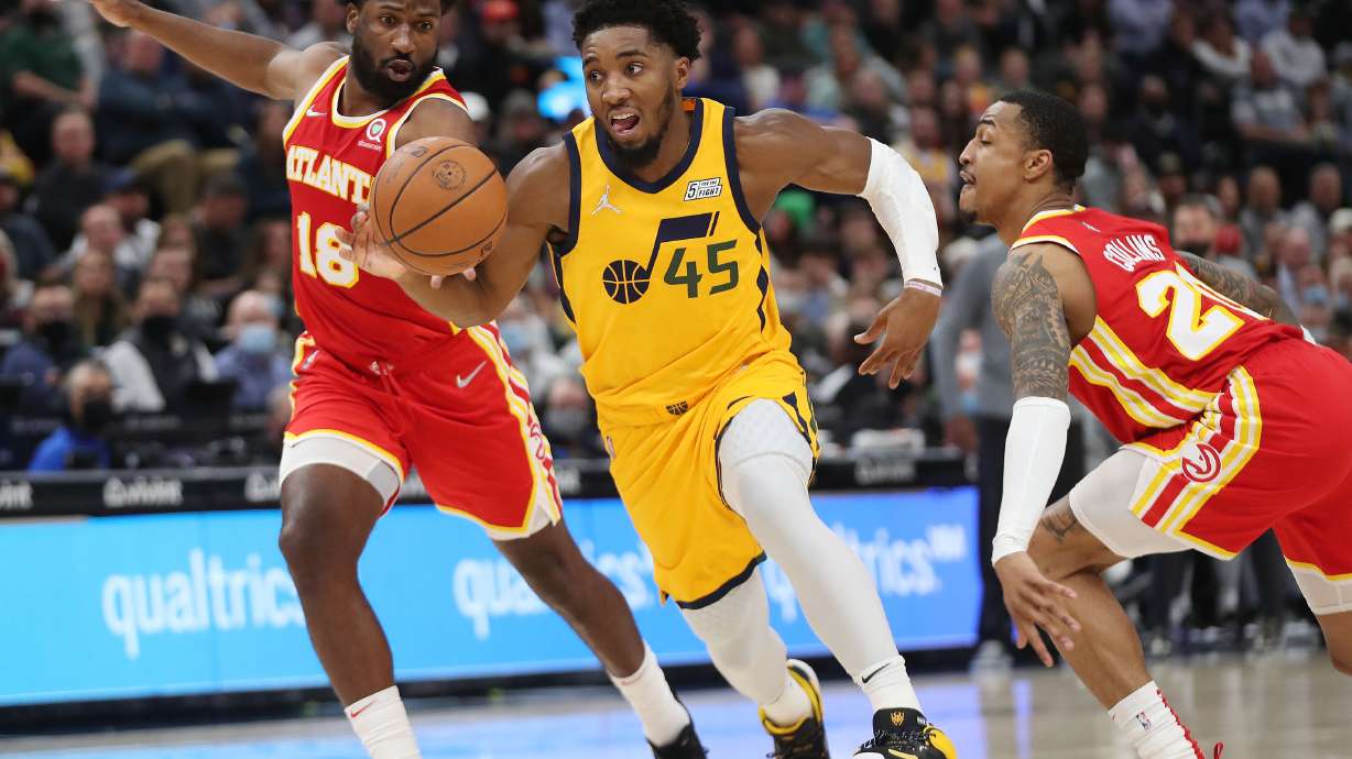 Utah Jazz guard Donovan Mitchell (45) drives on Atlanta Hawks forward Solomon Hill (18) in Salt Lake City on Tuesday, Nov. 9, 2021.