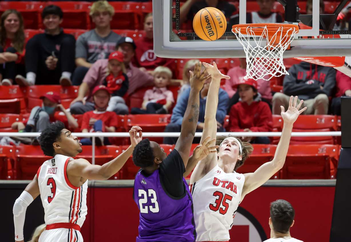 Abilene Christian Wildcats forward Airion Simmons (23) goes to the hoop against Utah Utes center Branden Carlson (35) at the Huntsman Center in Salt Lake City on Tuesday, Nov. 9, 2021.