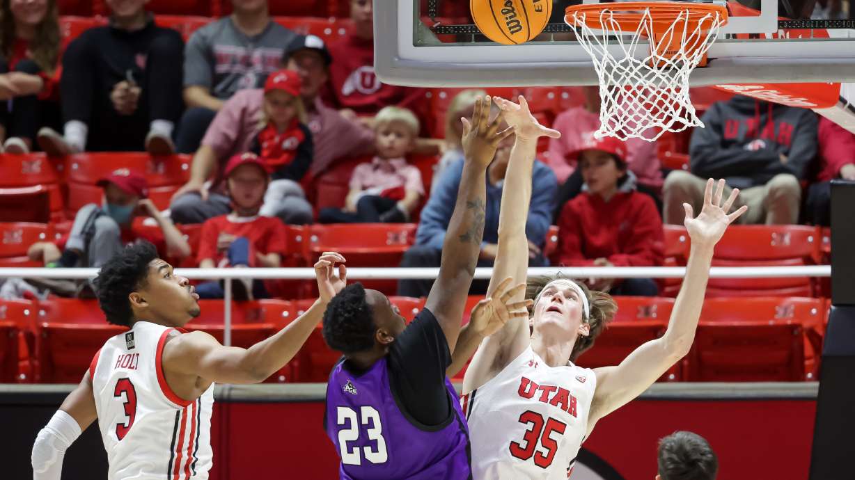 Abilene Christian Wildcats forward Airion Simmons (23) goes to the hoop against Utah Utes center Branden Carlson (35) at the Huntsman Center in Salt Lake City on Tuesday, Nov. 9, 2021.