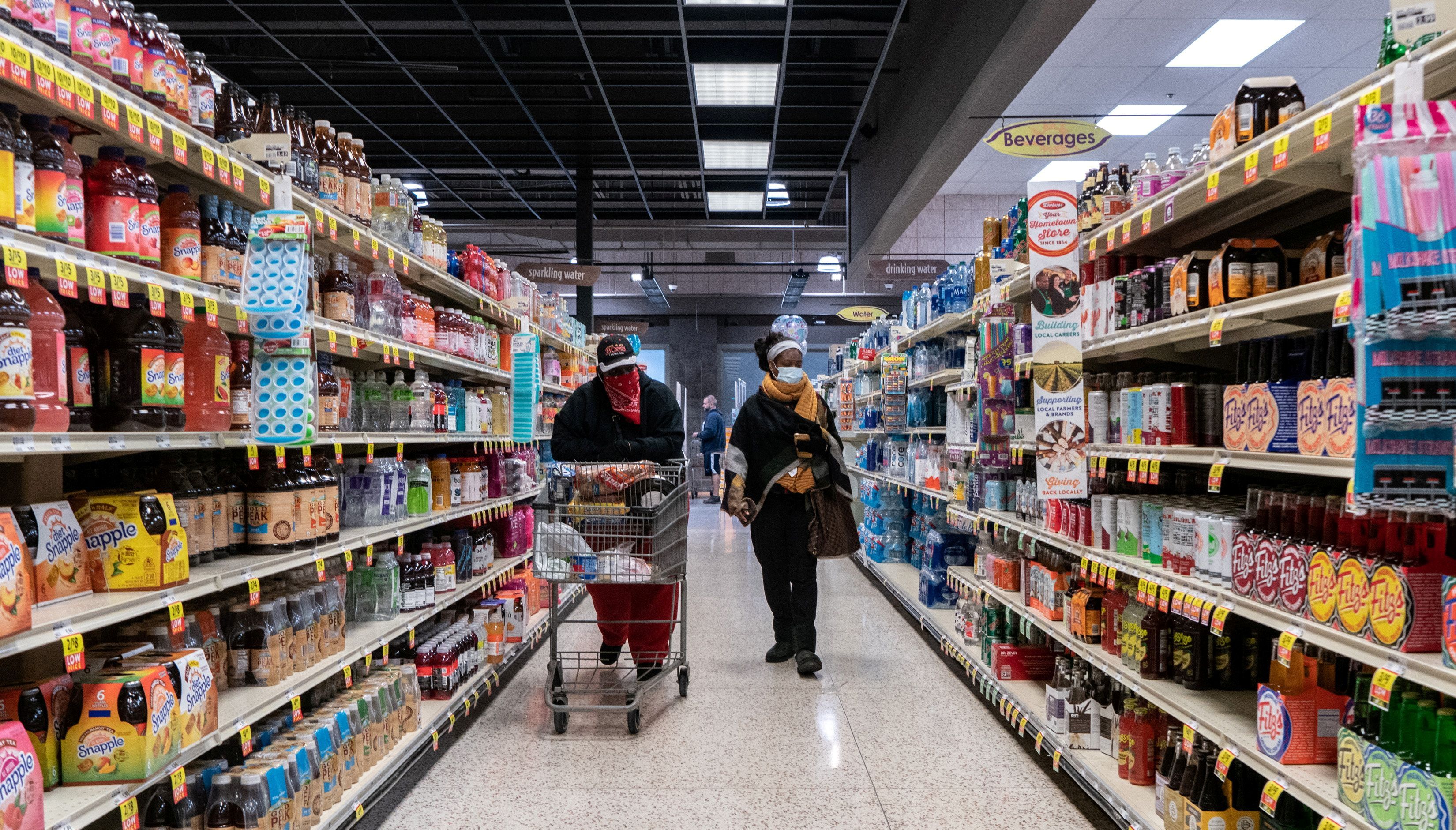 Shoppers browse in a supermarket while wearing masks to help slow the spread of coronavirus disease in north St. Louis, Missouri, U.S. April 4, 2020. U.S. consumer prices increased more than expected in October as the cost of gasoline and food surged, further signs that inflation could remain uncomfortably high well into next year.