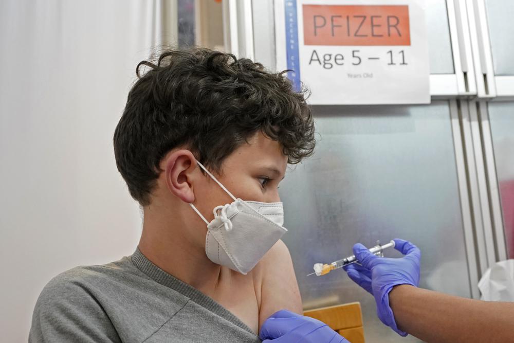 Leo Hahn, 11, gets the first shot of the Pfizer COVID-19 vaccine, Tuesday, at the University of Washington Medical Center in Seattle. Wednesday, the White House said about 900,000 children between 5 and 11 years old got a COVID-19 shot in the first week of eligibility.