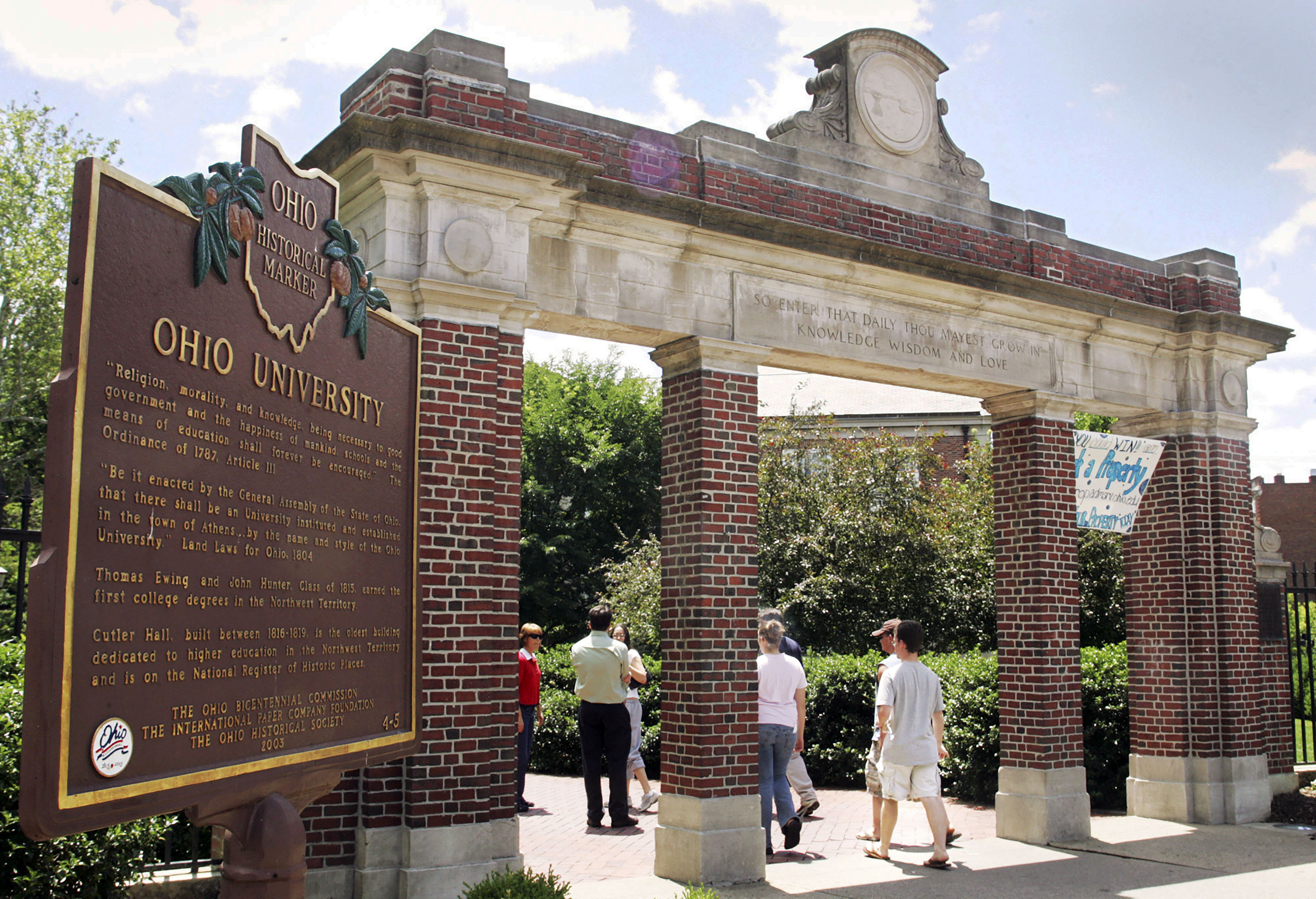 A historical marker stands near the gate at the Ohio University campus in Athens, Ohio, on June 12, 2006.  Universities that adopted COVID-19 vaccine mandates this fall of 2021, have seen widespread compliance. That's true even though many schools made it easy to get out of the shots by granting exemptions to nearly any student who requested one. 