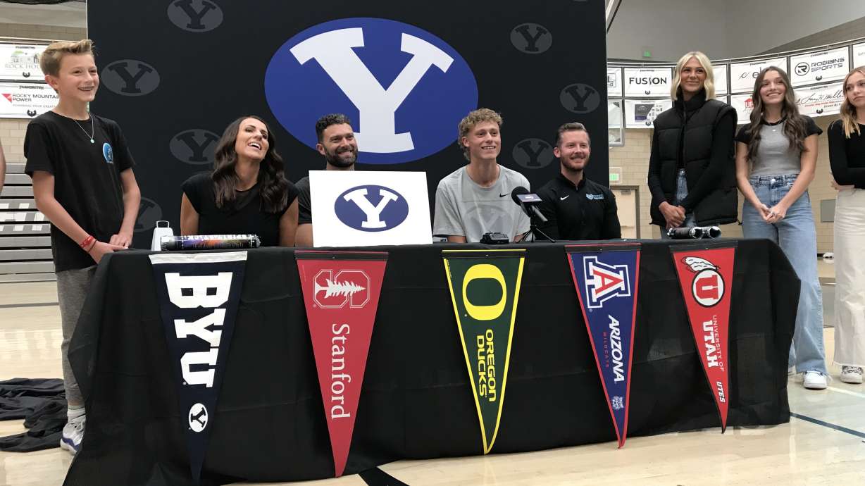 Farmington standout combo guard Collin Chandler with his parents, siblings, girlfriend and Phoenix coach Kasey Walkenhurst after committing to BYU, Wednesday, Nov. 10, 2021 in Farmington.