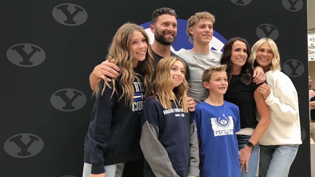 Farmington combo guard Collin Chandler, center, with his parents and siblings after Collin signed a National Letter of Intent to play basketball at BYU, Wednesday, Nov. 10, 2021 in Farmington.