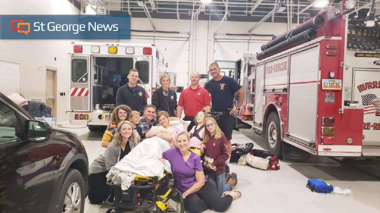 Midwife Elizabeth Smith, in purple top, emergency responders and the Seegmiller family, Hurricane, Utah, Sunday. A baby was delivered at a fire station in Hurricane.