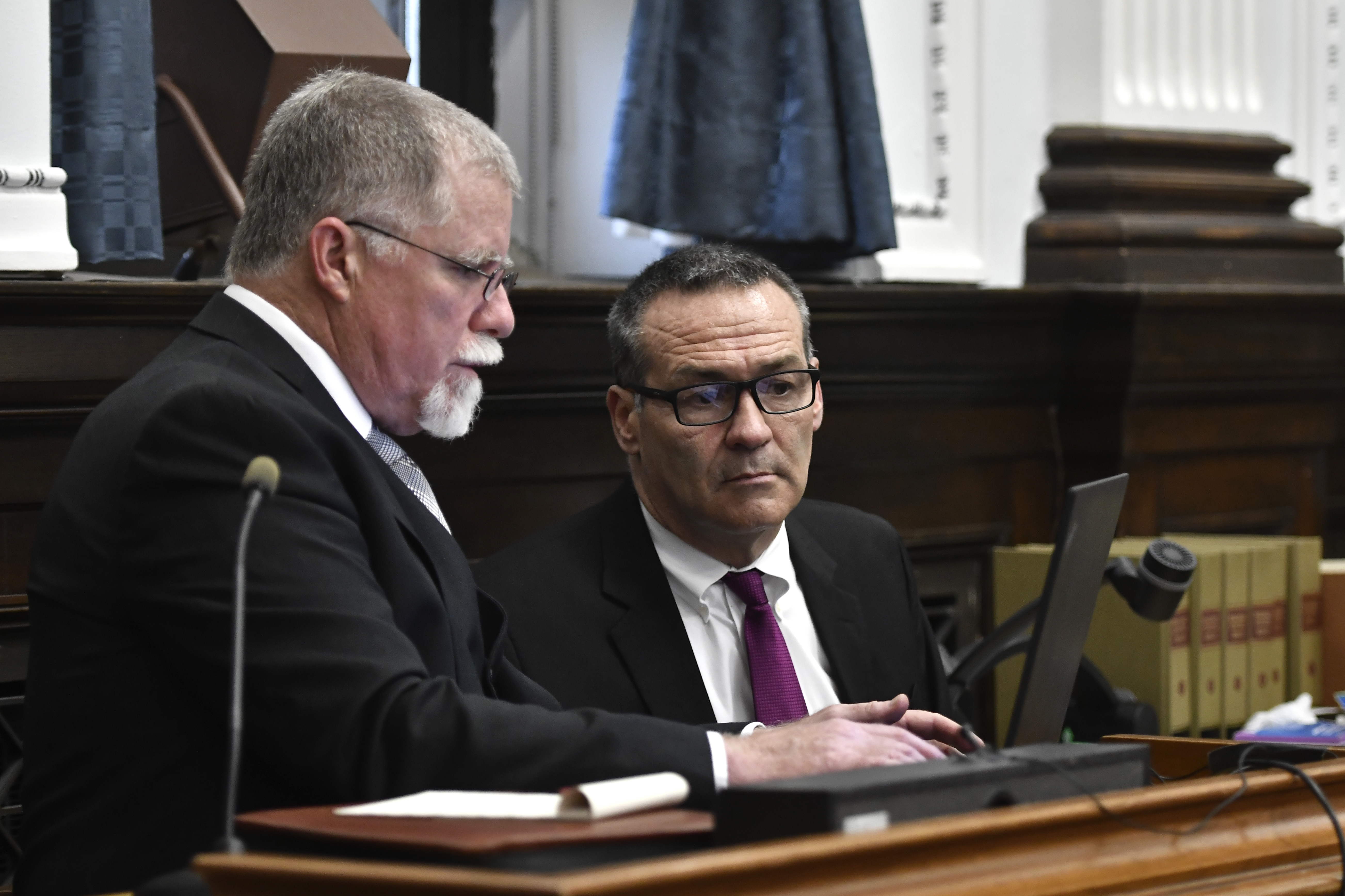 John Black, a use-of-force expert, left, works on relabeling video with help from Mark Richards, an attorney for Kyle Rittenhouse, during a break at the Kenosha County Courthouse in Kenosha, Wis., on Thursday.