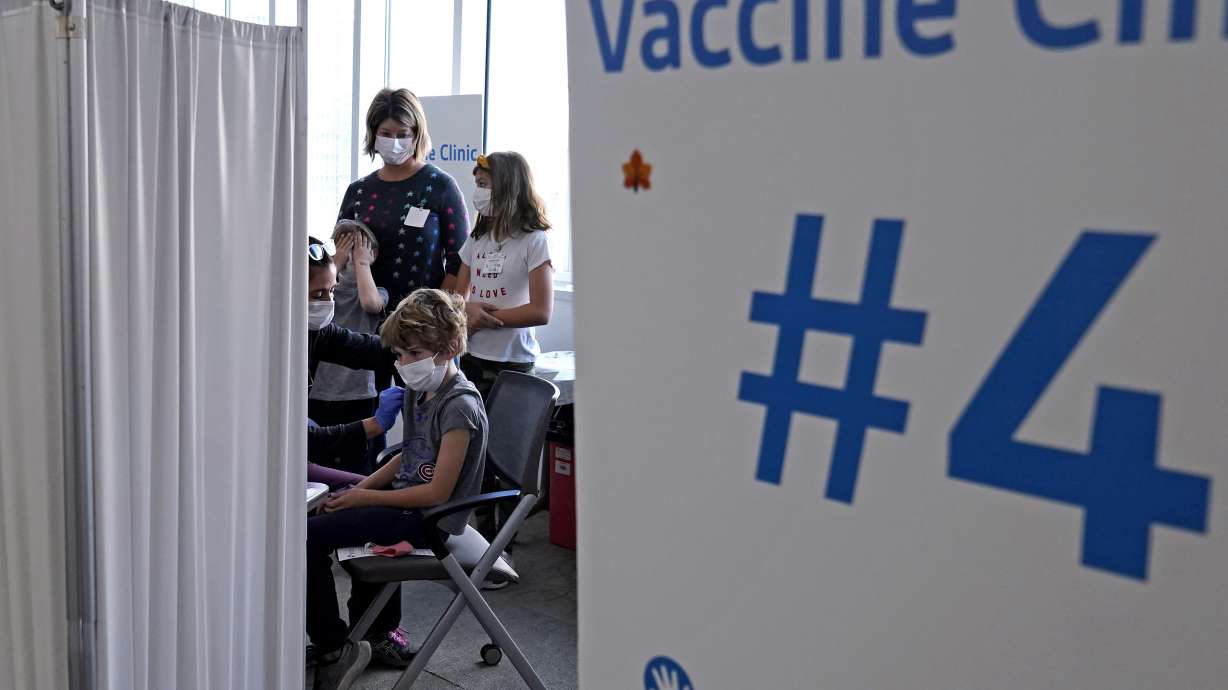 Graham Roark, 8, receives the Pfizer COVID-19 vaccine for children 5 to 11 years from Lurie Children's hospital registered nurse Virginia Scheffler at the hospital Nov. 5, in Chicago. First shots are averaging about 300,000 per day.