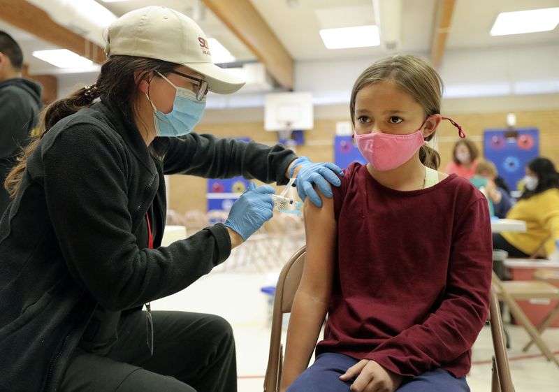 Josephine Snow, a Salt Lake County Health Department
community health worker and temporary vaccinator, gives Abbie
Whipple, 10, a COVID-19 vaccination at Hillsdale Elementary School
in West Valley City on Nov. 8. Whipple is a fifth
grader at Eastwood Elementary School.