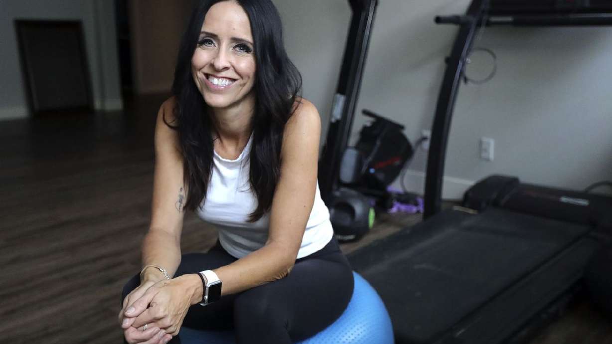Angie Taylor, who had her neck fused between C5, C6 and C7 with a cervical interbody device in March, poses for a portrait at her home in American Fork on Nov. 1. She is able
to workout again without pain.