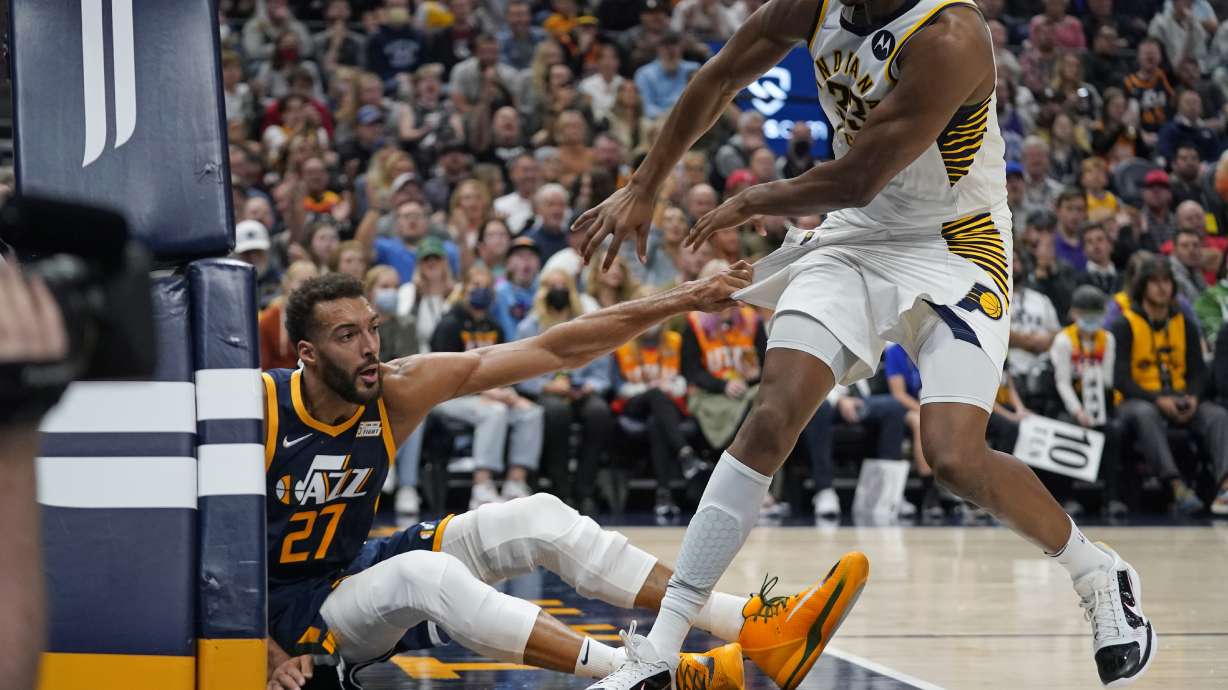 Utah Jazz center Rudy Gobert (27) pulls Indiana Pacers center Myles Turner (33) to the floor in the second half during an NBA basketball game Thursday, Nov. 11, 2021, in Salt Lake City. Gobert and Turner were ejected from the game.