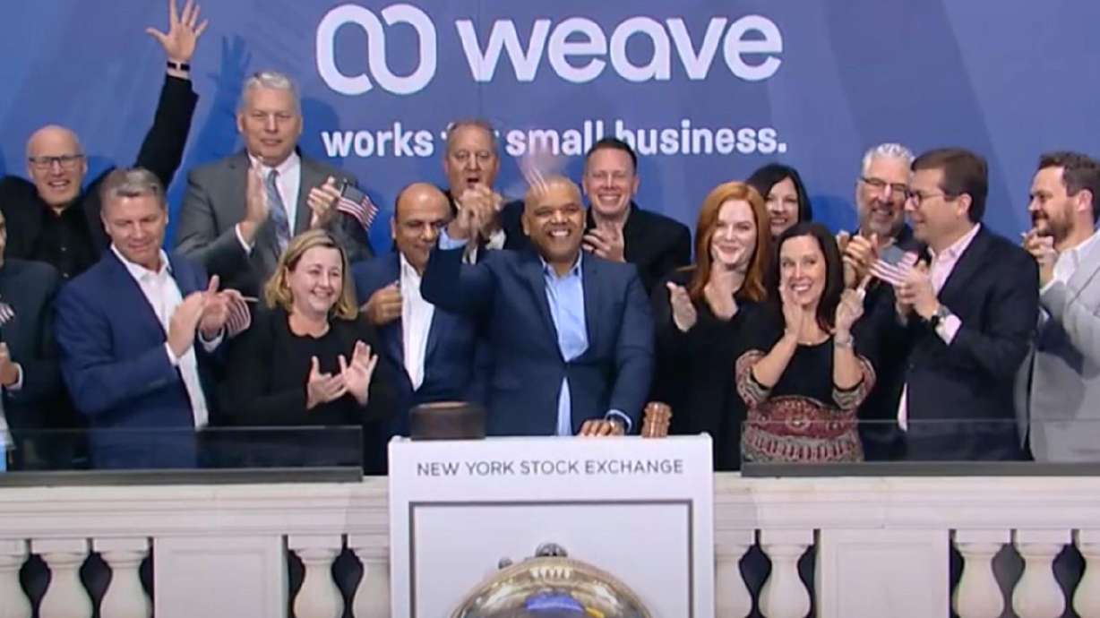 Weave CEO Roy Banks, center, celebrates with his team
during the company’s debut on the New York Stock Exchange on
Thursday.