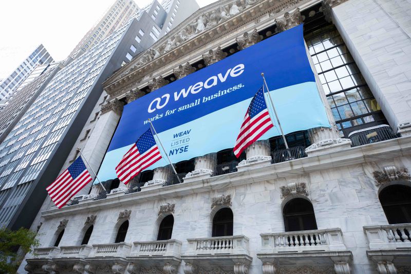 A banner for Utah tech company Weave hangs outside of
the New York Stock Exchange on Thursday, the day the
company’s stock went public.