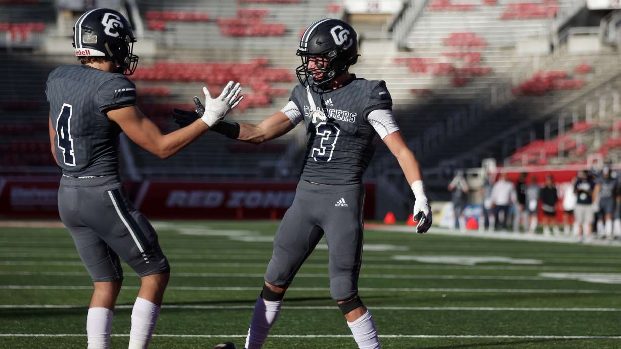 Corner Canyon’s Blaze DeGracie and Cody Hagen celebrate after a touchdown in a 6A football state semifinal game against Weber at Rice-Eccles Stadium in Salt Lake City on Friday, Nov. 12, 2021.