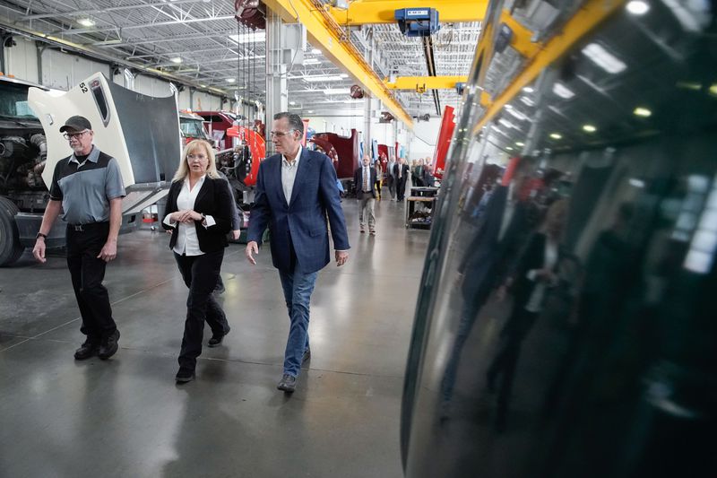 Kenworth Sales executive Sara Shaw, center, talks to
Sen. Mitt Romney, R-Utah, while giving a tour of the company in
West Valley City on Friday. During the tour, Romney
talked about supply chain issues.