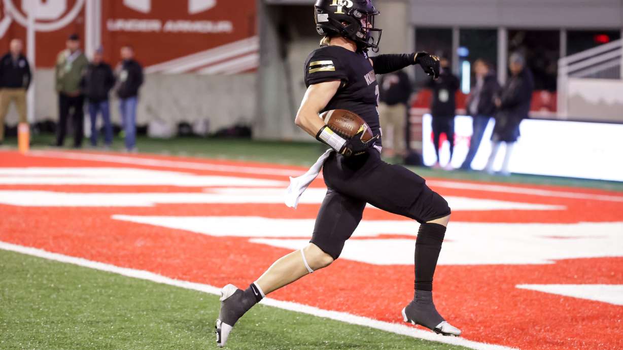 Lone Peak’s Crew McChesney runs a reception in for a touchdown in a 6A football semifinal game against Skyridge at Rice-Eccles Stadium in Salt Lake City on Friday, Nov. 12, 2021.