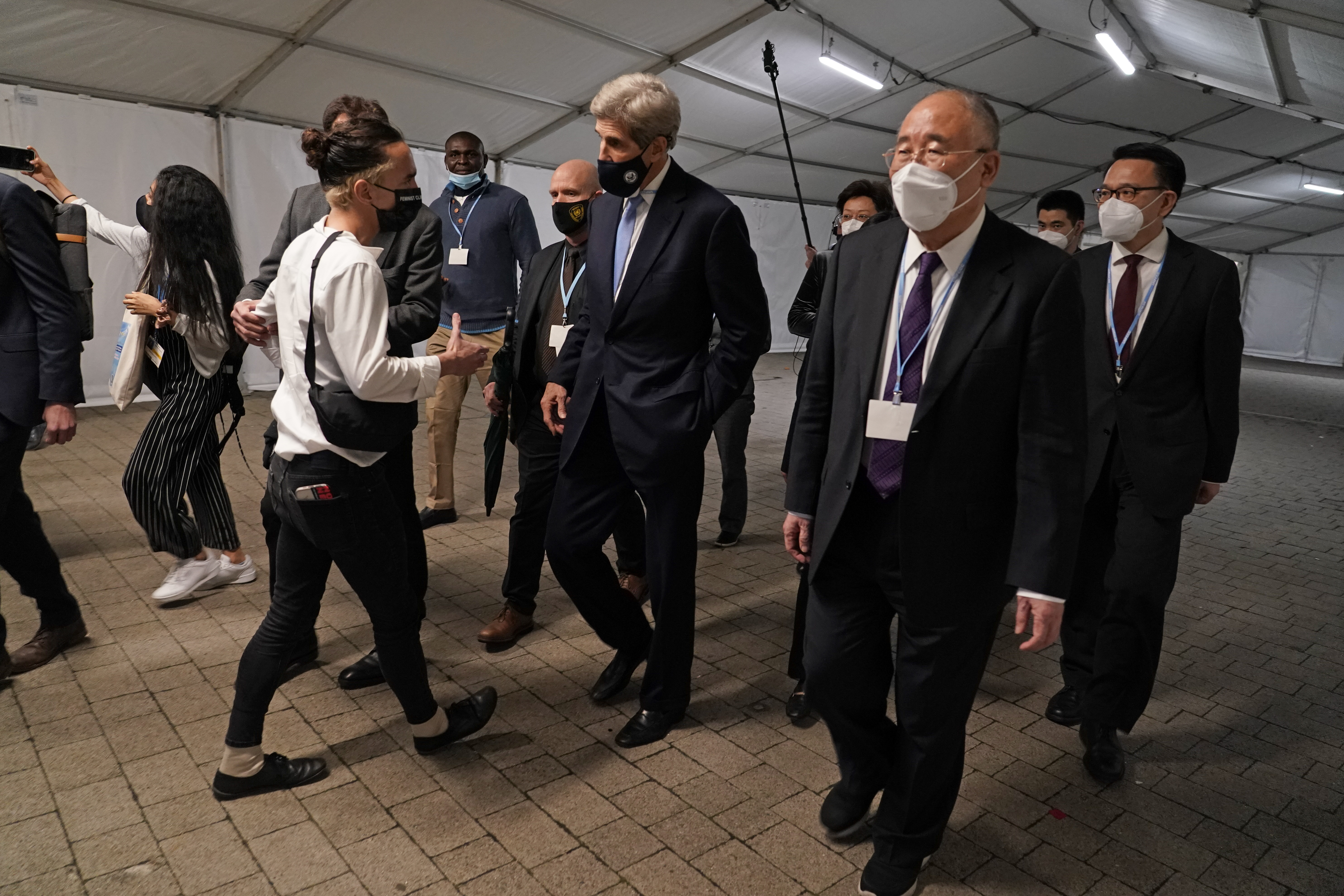 China's chief negotiator Xie Zhenhua, right, walks with John Kerry, United States Special Presidential Envoy for Climate at the COP26 U.N. Climate Summit in Glasgow, Scotland, Friday. Going into overtime, negotiators at U.N. climate talks in Glasgow are still trying to find common ground on phasing out coal, when nations need to update their emission-cutting pledges and, especially, on money.