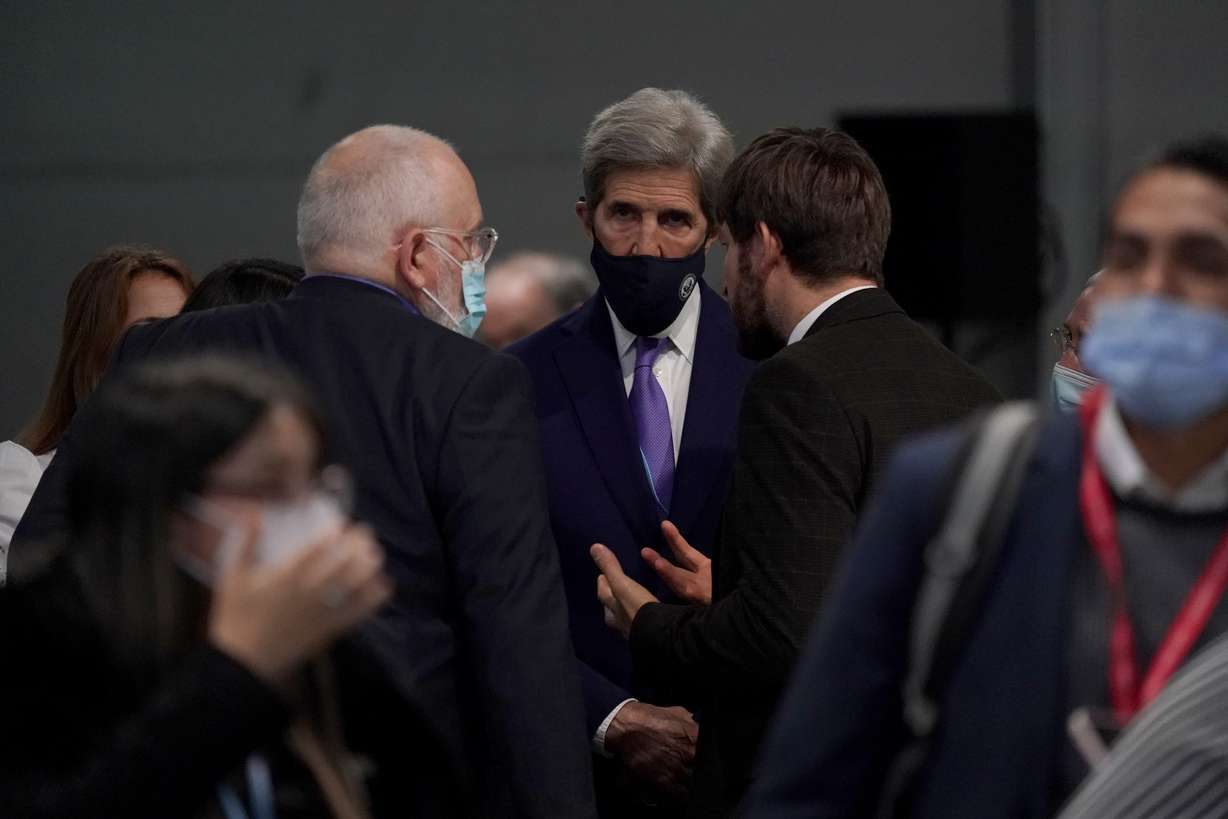 John Kerry, center, United States Special Presidential Envoy for Climate, Ruslan Edelgeriyev, right, Russia's Special Presidential Representative on Climate Issues and European Commissioner for European Green Deal Frans Timmermans, left, speak as they attend a stocktaking plenary session at the COP26 U.N. Climate Summit, in Glasgow, Scotland, Saturday.