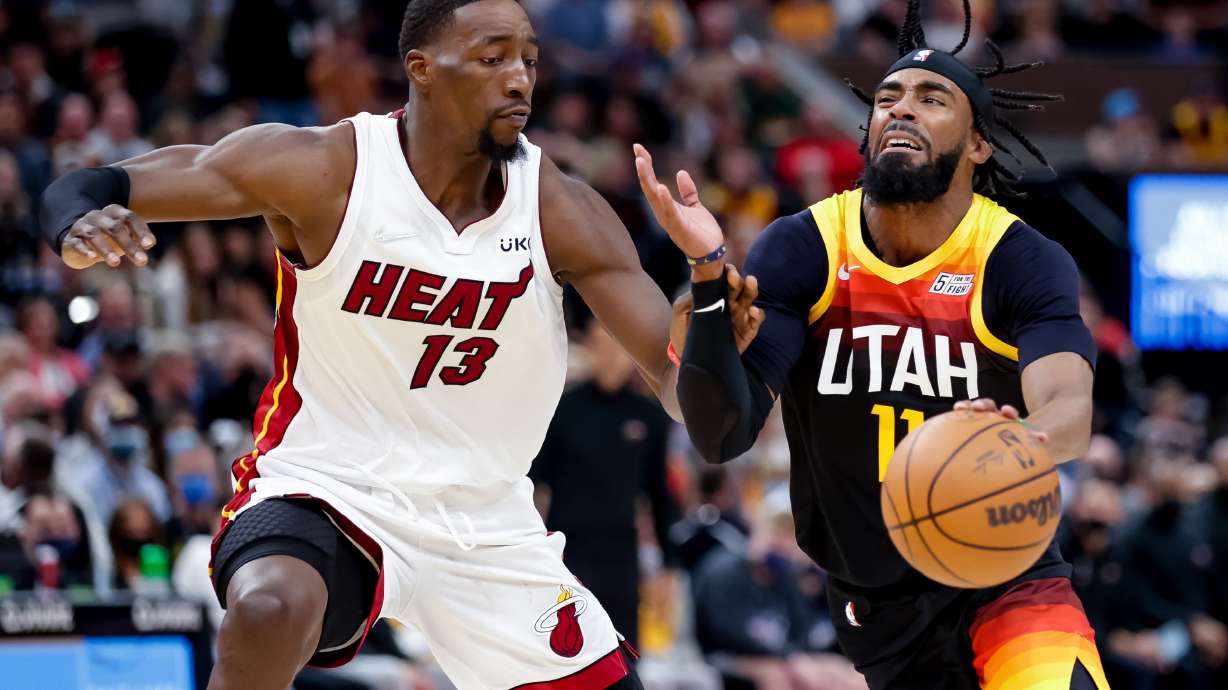 Utah Jazz guard Mike Conley (11) drives against Miami Heat center Bam Adebayo (13) during the game at Vivint Arena in Salt Lake City on Saturday, Nov. 13, 2021.