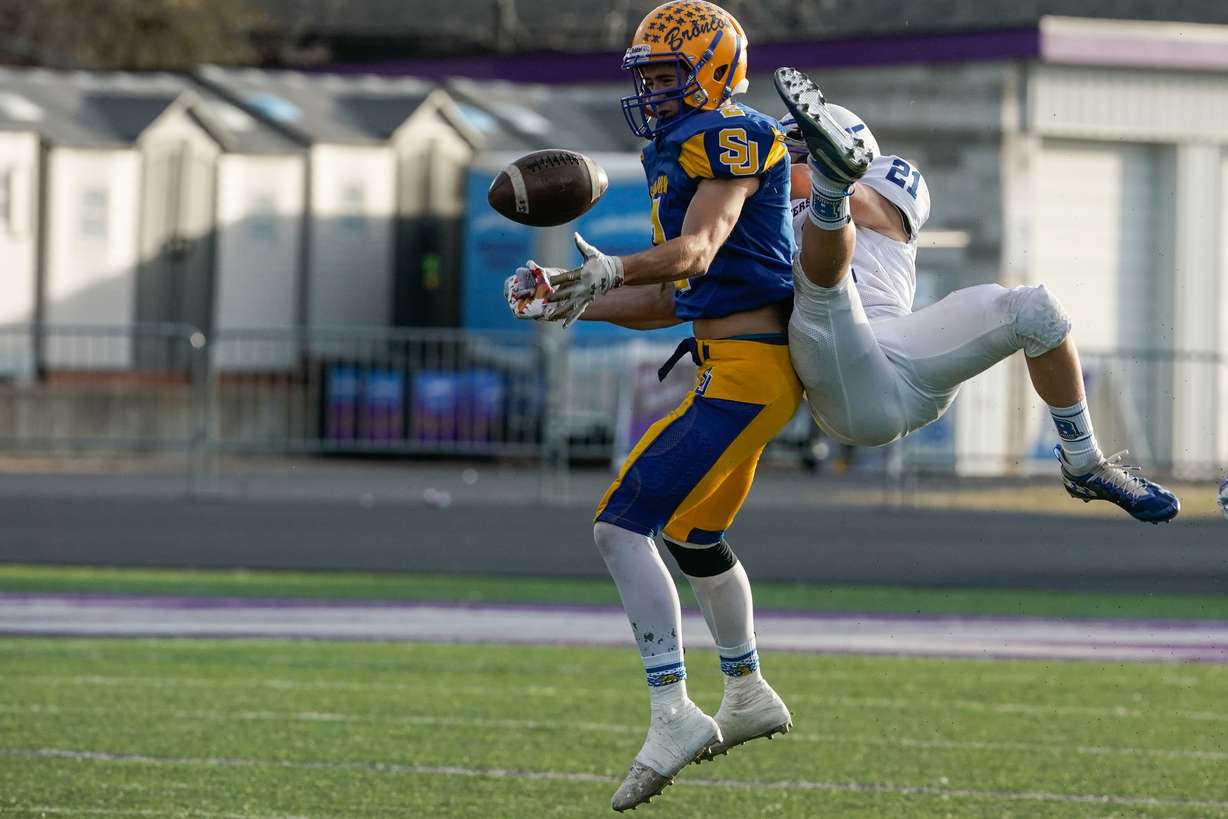 San Juan’s Jersey Nieves, left and Beavers Tavyn Hollingshead reaches fights for the ball as they compete in the 2A football championship game on Saturday, Nov. 13, 2021 at Stewart Stadium in Ogden.