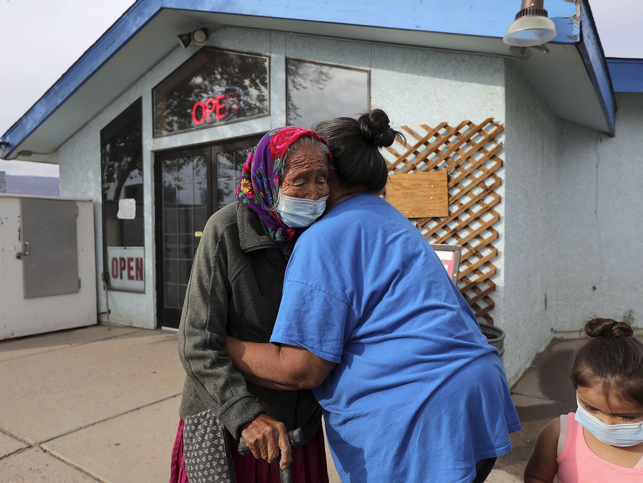 Rose Salt, 93, gets a hug from granddaughter Susie Denetsosie outside of The Blue Coffee Pot Restaurant in Kayenta, Ariz., in the Navajo Nation on Thursday, Sept. 30, 2021. Salt often runs into family and friends at the restaurant after months of isolation due to COVID-19.