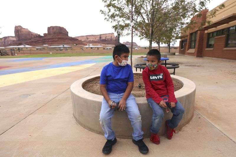 Fourth graders Darrell Lee and Braylon Stash chat on
the playground at Tse’Bii’Nidzisgai Elementary School in
Oljato-Monument Valley, San Juan County, on Sept. 30.