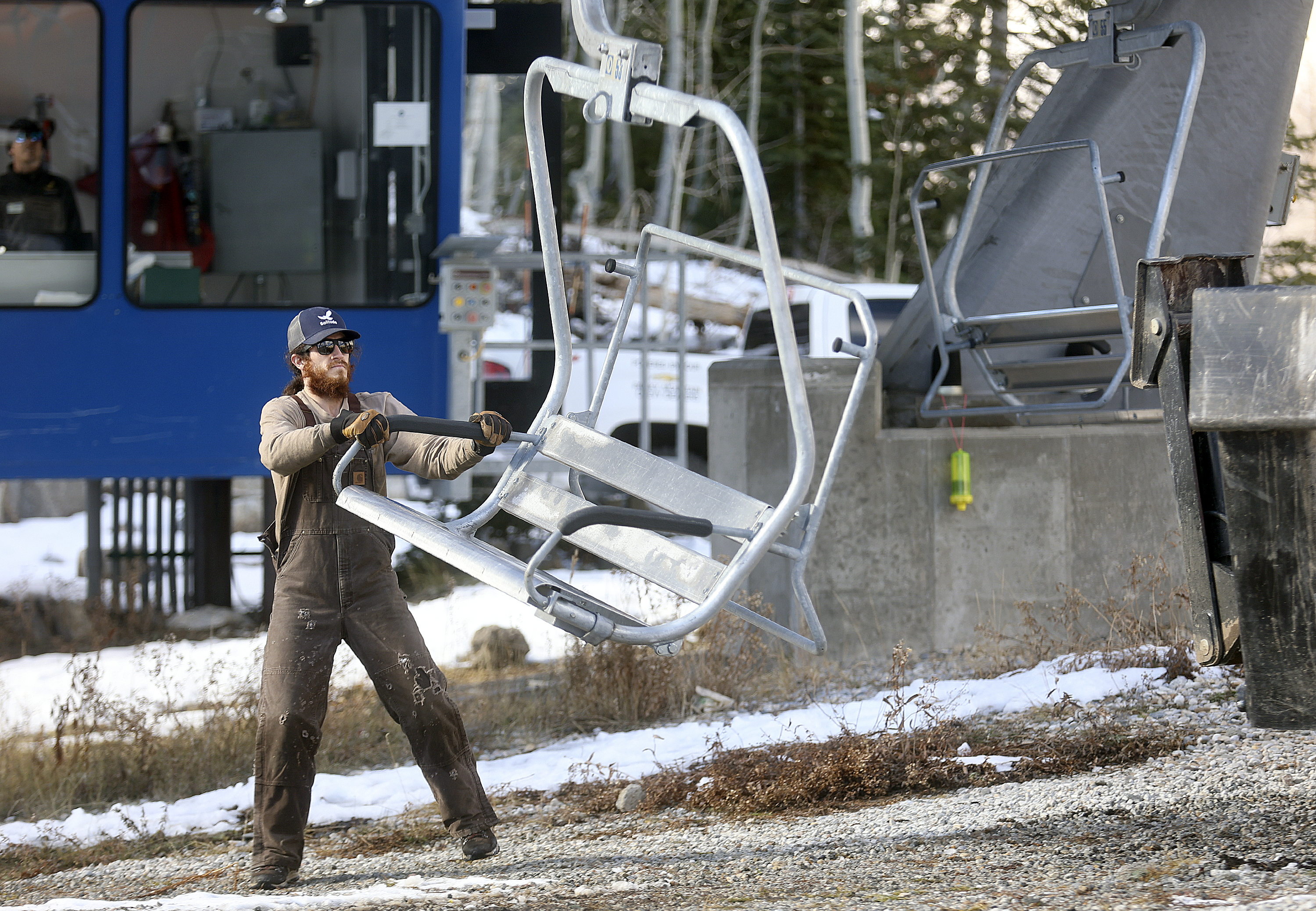 Cody Reed loads chairs onto the Moonbeam Express chairlift in preparation for the opening of the upcoming ski season at Solitude Mountain Resort in Salt Lake City on Oct. 28.